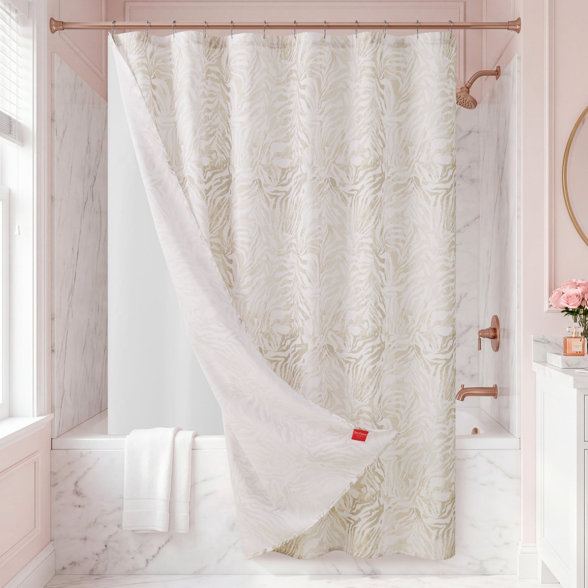 Elevate your bathroom with the Stassi Shower Curtain with PEVA Liner and Hooks 14-Piece Set, featuring an eye-catching white and beige zebra pattern. The statement curtain is partially pulled back to reveal a sleek white tub, while marble walls, neatly folded white towels, and fresh pink roses in a vase add elegant decorative touches.