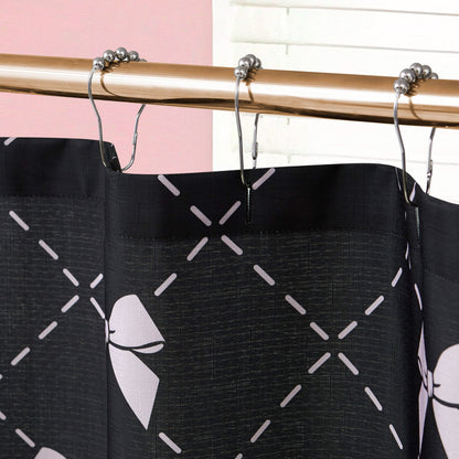 A close-up of the Shower Curtain and Hooks Set featuring a pink bow and crisscross pattern, hanging from metal hooks. This fabric curtain adds a chic accent to your bathroom, shown with a pink wall and white blinds in the background.
