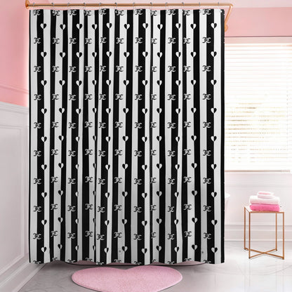 A bathroom with a PEVA Shower Curtain Liner in black-and-white stripes featuring heart and letter J patterns, pink walls, a round pink rug, and folded pink towels on a white stool by the window.