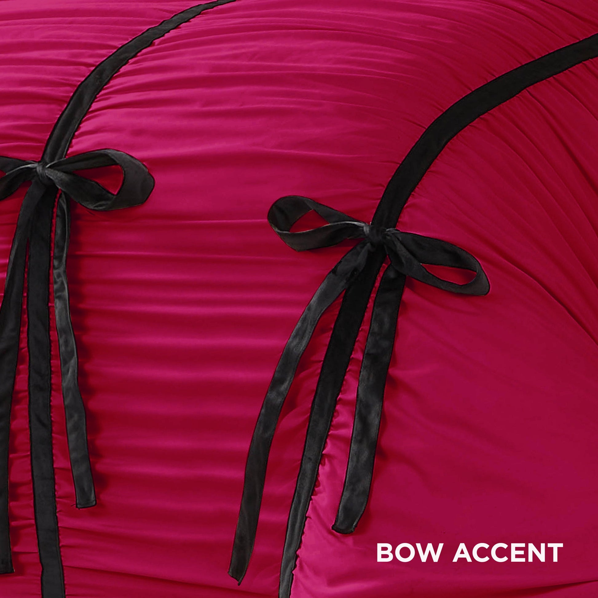 Close-up of the Amelie Bows Ruched Comforter Set in hot pink, featuring ruched fabric, two black satin and velvet bows, and black piping. “BOW ACCENT” appears in white text at the bottom right corner.