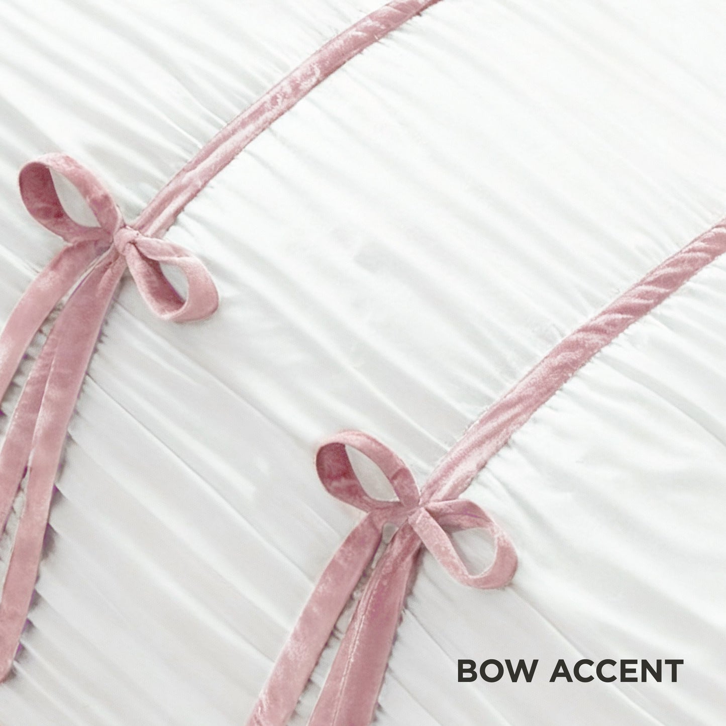Two pink velvet bows sit atop pleated white fabric with diagonal pink trim, echoing the style of the Amelie Bows Ruched Comforter Set. "BOW ACCENT" is displayed in the bottom right corner.
