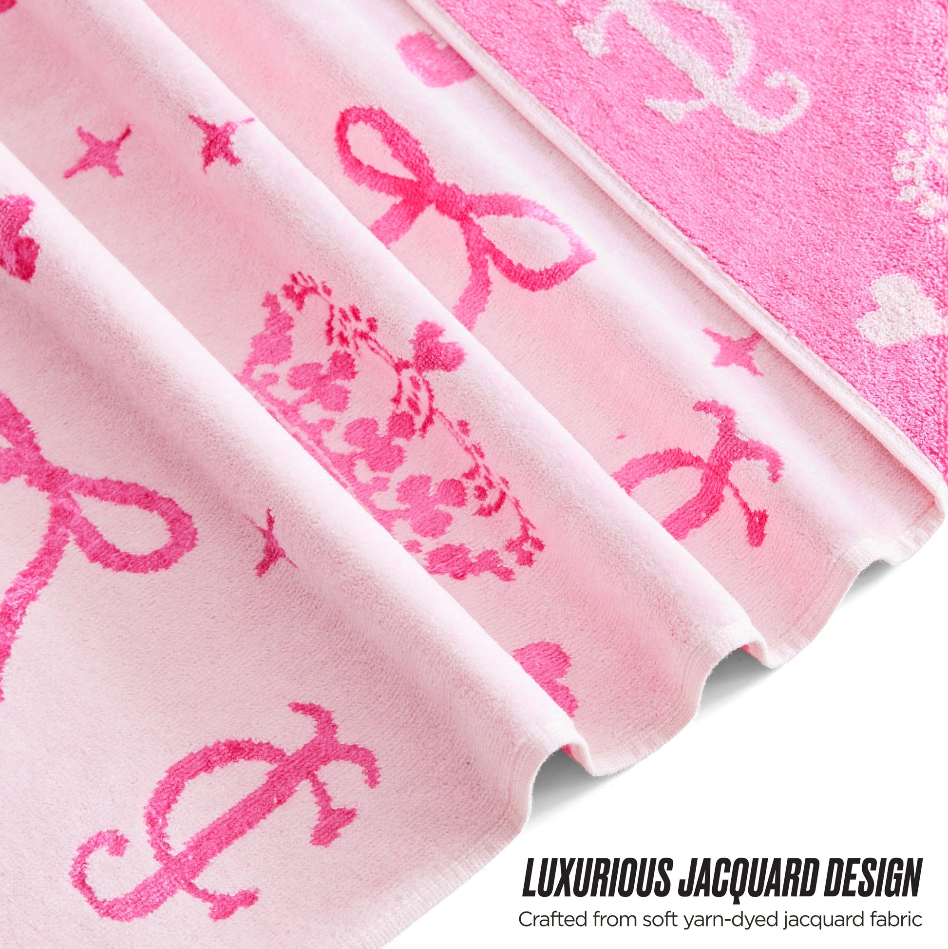 Close-up of the Printed Jacquard Bath Towel Set in pink, featuring crown, bow, and letter motifs in darker pink. “Luxurious Jacquard Design. Crafted from soft yarn-dyed jacquard fabric.” Inspired by Juicy Couture style.
