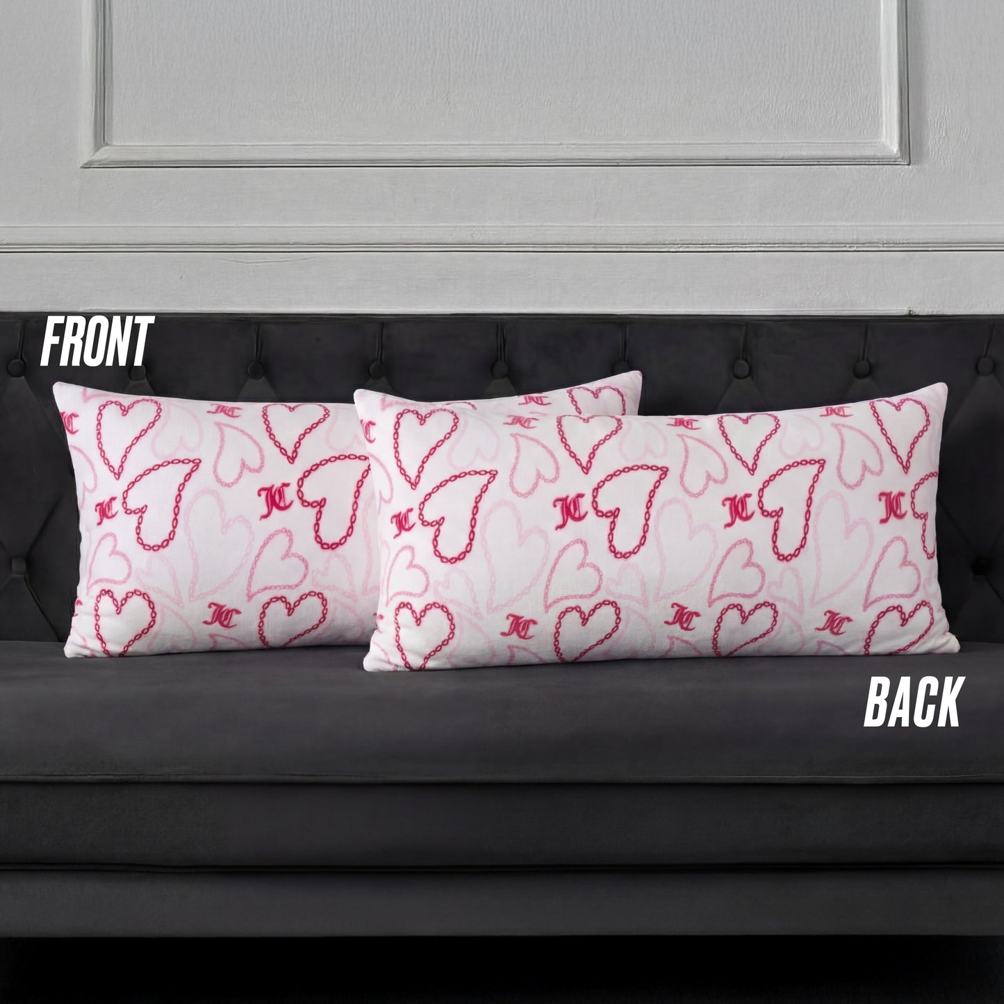 Three rectangular white pillows with pink and red hearts, including a Plush Body Pillow, are arranged on a dark gray tufted sofa. Labels FRONT and BACK indicate the pillow positions.