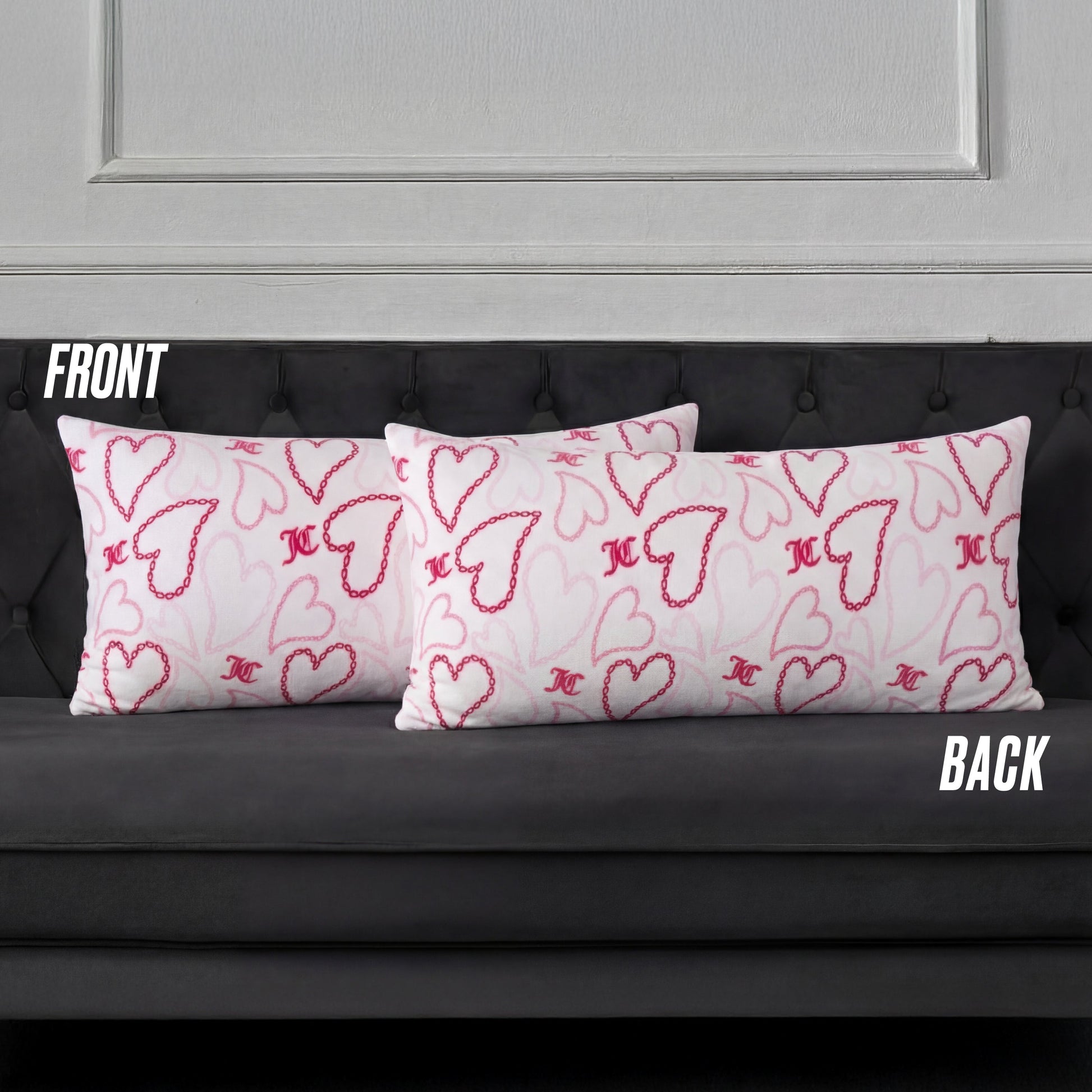 Three rectangular white pillows with pink and red hearts, including a Plush Body Pillow, are arranged on a dark gray tufted sofa. Labels FRONT and BACK indicate the pillow positions.