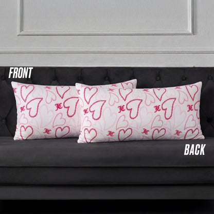 Three rectangular white pillows with pink and red hearts, including a Plush Body Pillow, are arranged on a dark gray tufted sofa. Labels FRONT and BACK indicate the pillow positions.