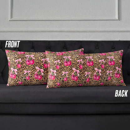 Two rectangular Plush Body Pillows on a black couch display a pink cherry and brown leopard print, reminiscent of Juicy Couture. Labels "FRONT" and "BACK" show both sides of the design.