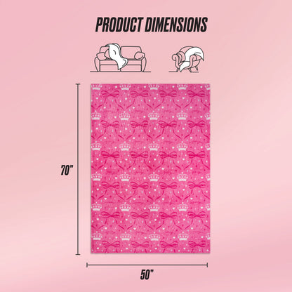 The Kids Plush Throw Blanket features crown and bow patterns, measures 70"x50", and is shown on a pink gradient background with product dimensions plus icons of a couch and a woman enjoying this ultra-soft blanket.