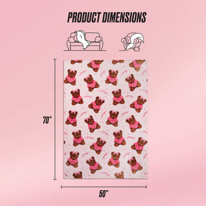 A rectangular pink Kids Plush Throw Blanket with a teddy bear pattern is shown, measuring 70 x 50 inches. Icons highlight its ultra-soft use for couch or bed, with Product Dimensions text also included.