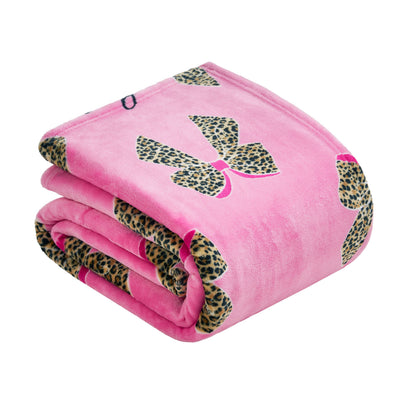 The Plush Oversized Throw Blanket is a folded pink Juicy Couture piece with large leopard print bows and small pink accents—an ultra-soft blanket ideal for cozying up in style.