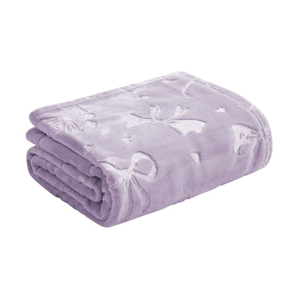 A neatly folded light purple Embossed Plush Oversized Throw Blanket by Juicy Couture, featuring a subtle embossed pattern of bows, hearts, and flowers.