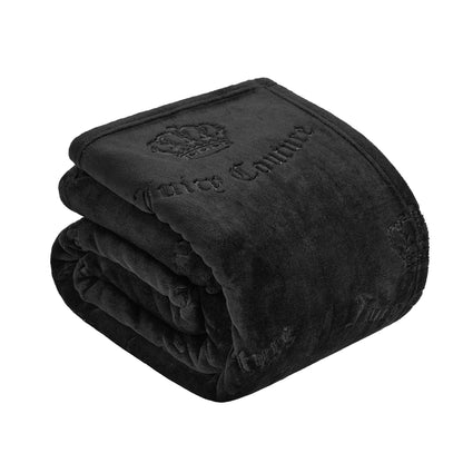 The Embossed Plush Oversized Throw Blanket in black, folded to display its logo and crown embossing, offers luxurious softness and a touch of elegance to any space.
