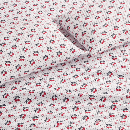 The Printed Microfiber Sheet Set features white sheets and pillowcases with a playful pattern of small red cherries, black leaves, and tiny black polka dots, adding cheerful style and luxurious comfort to your room.