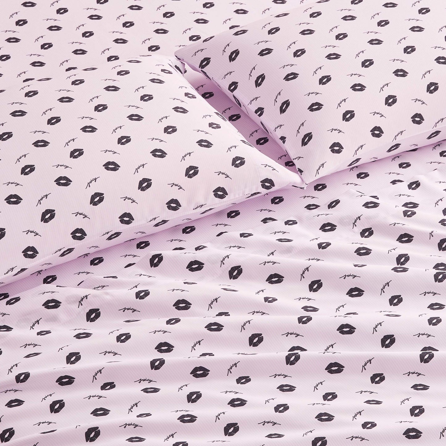The Printed Microfiber Sheet Set in light pink features a chic pattern of black lips and eyelashes. Smooth and neatly arranged, this luxury bedding adds modern style to any room.