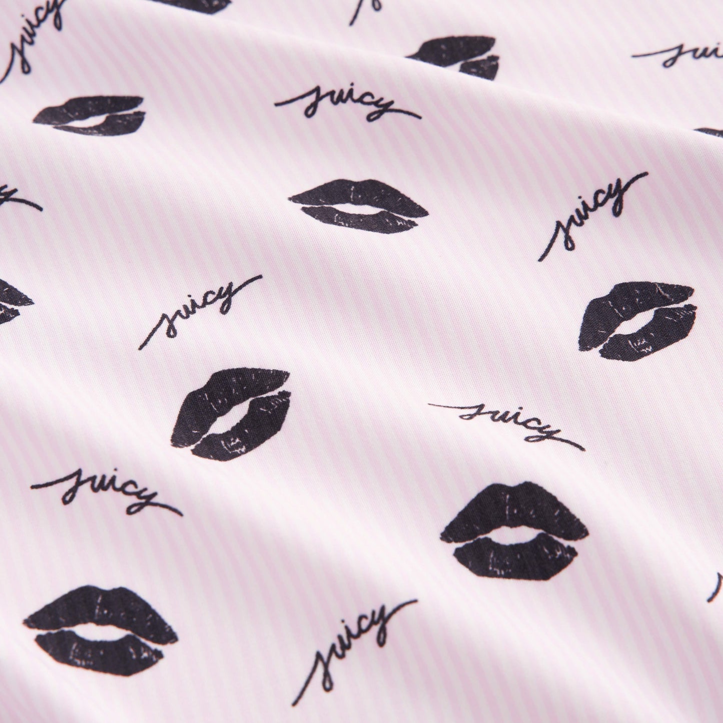 The Printed Microfiber Sheet Set features white fabric with light pink stripes, black lip prints, and “juicy” in cursive—adding playful charm and style to your bedding collection.