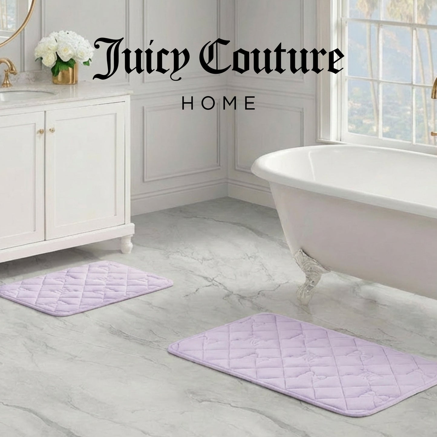 Elegant bathroom with white vanity, freestanding tub, and two light purple Quilted Memory Foam Bath Mats (2-Piece Set) on a marble floor. Large window in the background. Juicy Couture Home logo appears at the top.