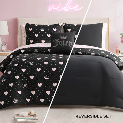 Create a glam bedding retreat with the Diamond Hearts Black Comforter Bed in a Bag Bedding Set, featuring black and pink hearts, crowns, and dots on one side and solid black on the other—all styled atop a light-colored bed frame.