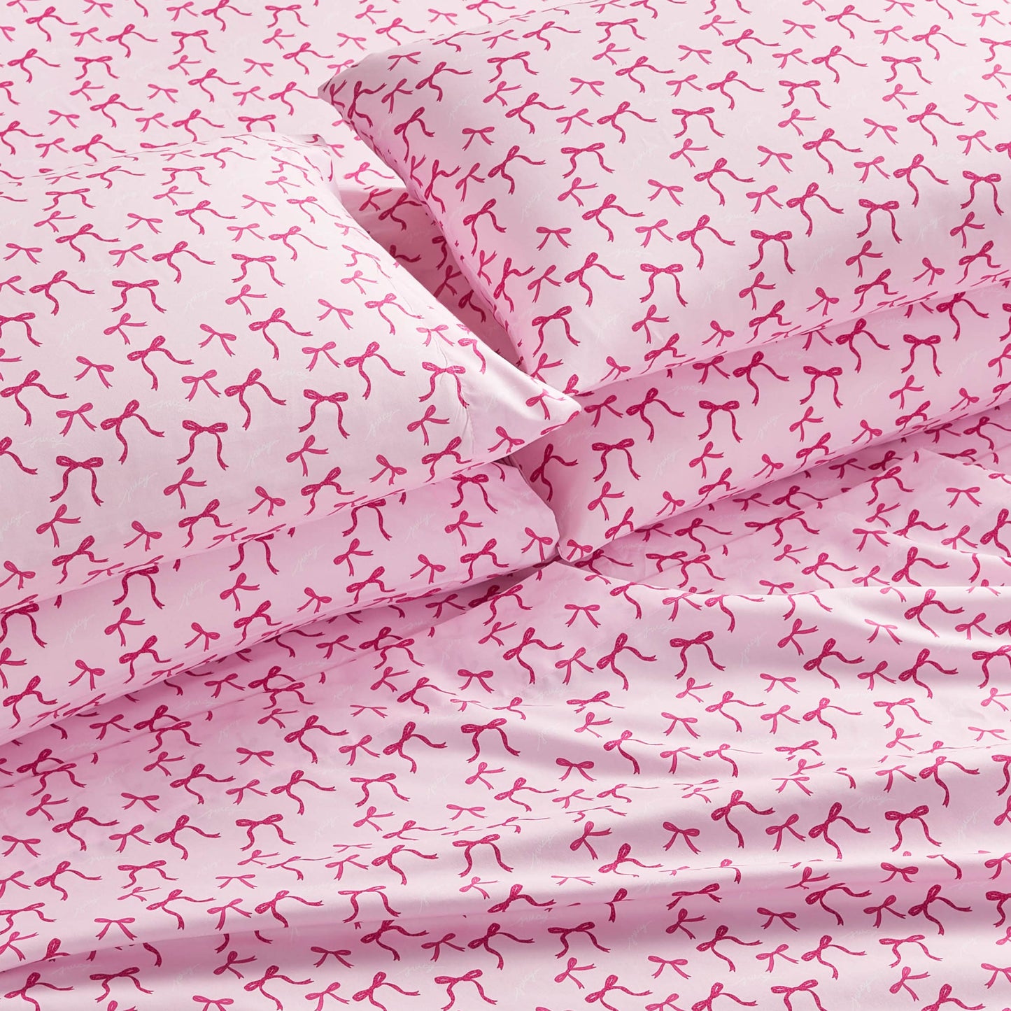 The Microfiber Sheet Set With Extra Pillowcases offers pink sheets and pillows with a repeating red breast cancer ribbon pattern. Made of smooth microfiber, this bedding ensures comfort and features a stylish, consistent design throughout.
