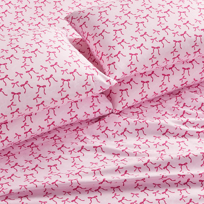 The Microfiber Sheet Set With Extra Pillowcases offers pink sheets and pillows with a repeating red breast cancer ribbon pattern. Made of smooth microfiber, this bedding ensures comfort and features a stylish, consistent design throughout.