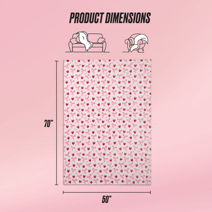 A Kids Plush Throw Blanket by Juicy Couture features a pink cherry pattern and measures 70x50 inches. Icons indicate sofa and wearable uses, while a soft pink gradient background highlights the ultra-soft plush texture. Text: Product Dimensions.