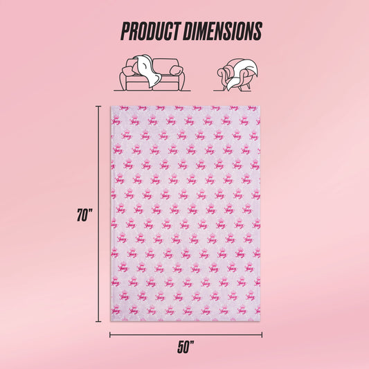 A pink background displays the Kids Plush Throw Blanket by Juicy Couture, measuring 70x50 inches with a pink pattern. Icons illustrate its use on a couch and over shoulders, with “Product Dimensions” written above.