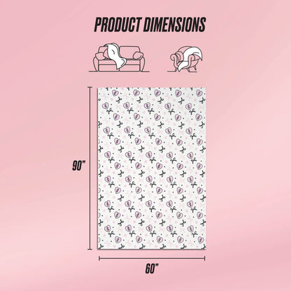 A graphic displays the Plush Oversized Throw Blanket (90"x60") on a pink background. Above, illustrations show its ultra-soft texture as it covers a couch and person. The blanket features a white base with repeating black and pink designs.