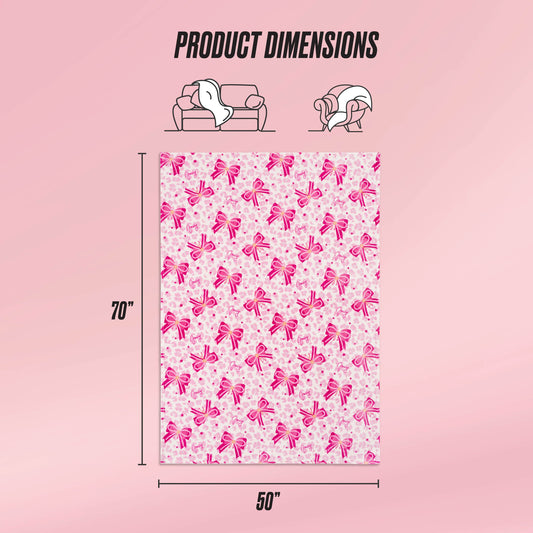The Kids Plush Throw Blanket measures 70"x50" and features vertical pink ribbon designs. Ultra-soft and cozy, it’s perfect for lounging—ideal for use on a couch or while relaxing.