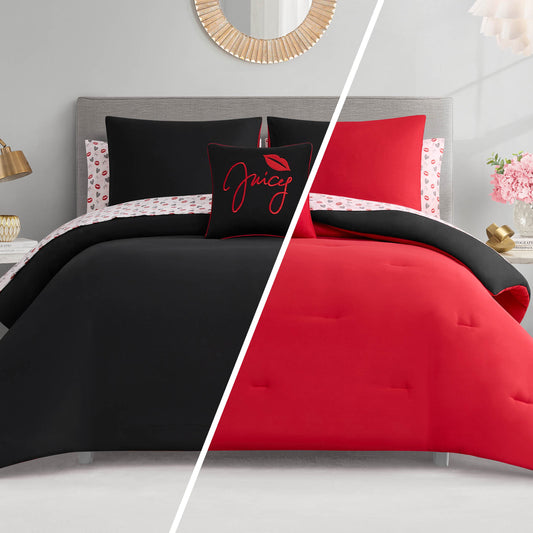 A modern bedroom showcases the Glam Girl Solid Reversible Bed in a Bag Bedding Set—black bedding with red and white accents on one side, red with black and white on the other—finished with stylish pillows and lamps.