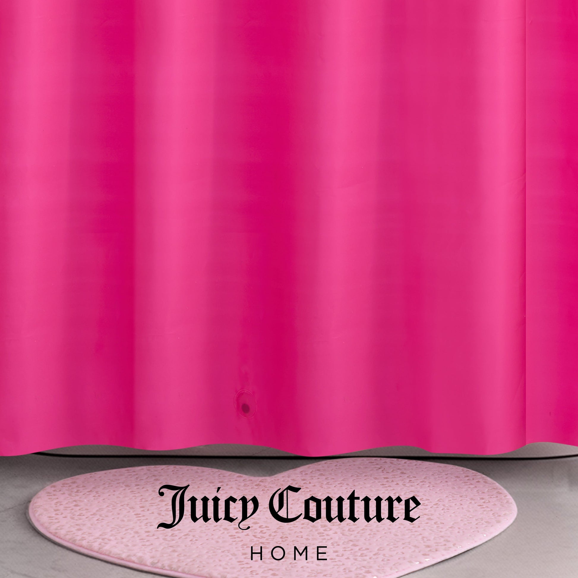 A bright pink PEVA Shower Curtain Liner hangs above a light pink, heart-shaped rug with speckles. The words Juicy Couture Home are printed in black at the bottom center of the image.