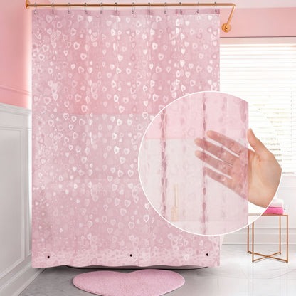 A PEVA Shower Curtain Liner with a subtle heart pattern hangs in a bathroom with pink walls and accents. An inset shows a hand behind the semi-transparent liner, highlighting its see-through quality.