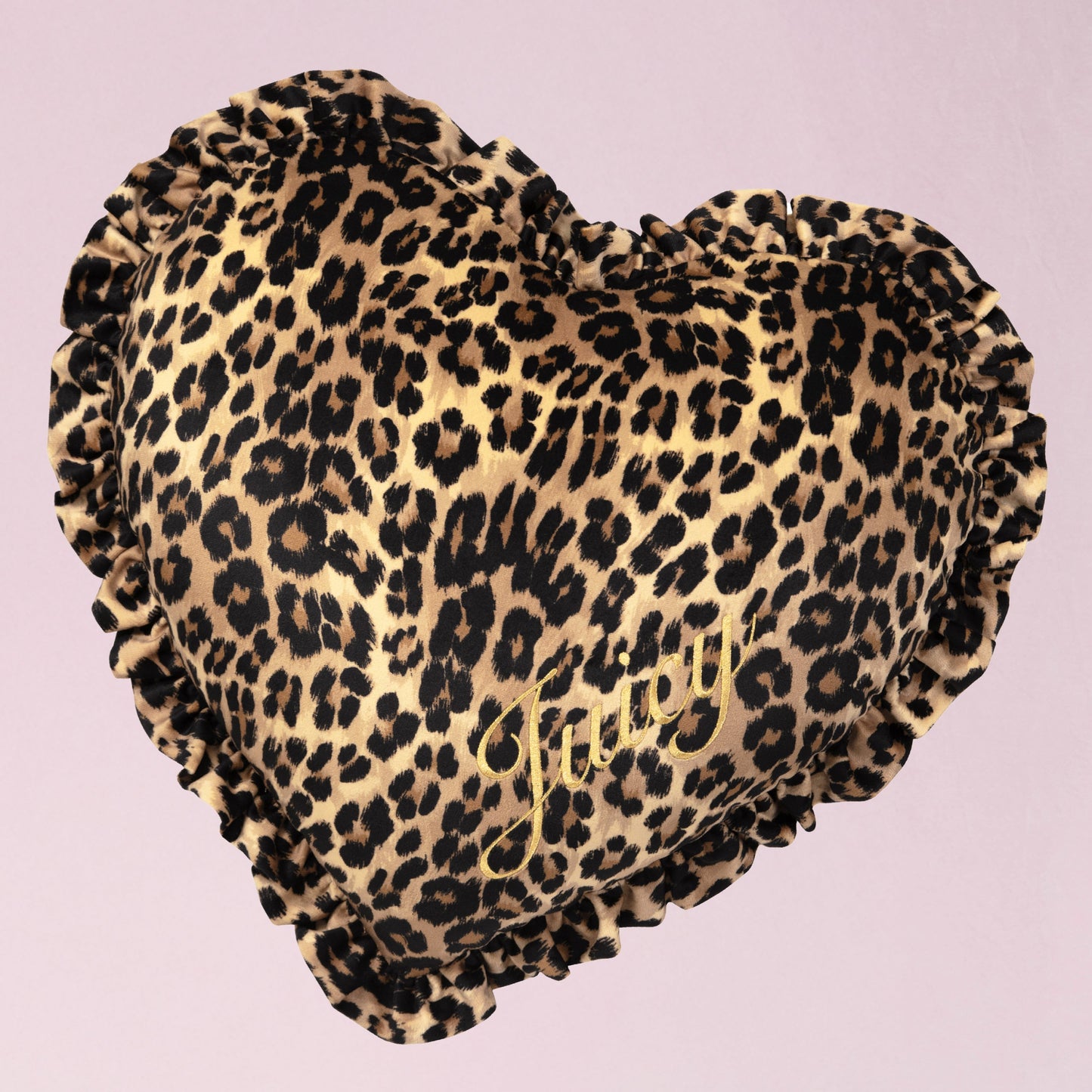 The Heart Shaped Decorative Pillow features a pink cheetah print design, ruffled edges, and gold "Juicy" script—an ideal accent piece for any Juicy Couture fan’s room.