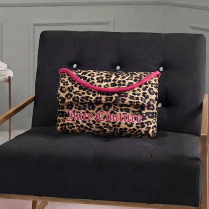 A Purse Decorative Pillow with leopard print, pink trim, and bold Juicy Couture lettering adds a trendy touch to a modern black armchair with wooden armrests in a stylish room.