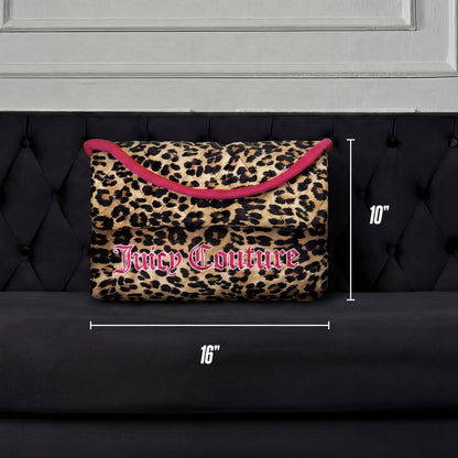 The Purse Decorative Pillow, featuring a leopard print with pink trim and logo, measures 16" x 10" and is shown on a black tufted sofa against a white panel backdrop—a chic accent for any room.