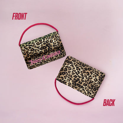 Two leopard print Purse Decorative Pillows with pink handles rest on a pink background. The front pillow features "Juicy Couture" in pink text, while the back highlights only the print—a stylish decorative accent.