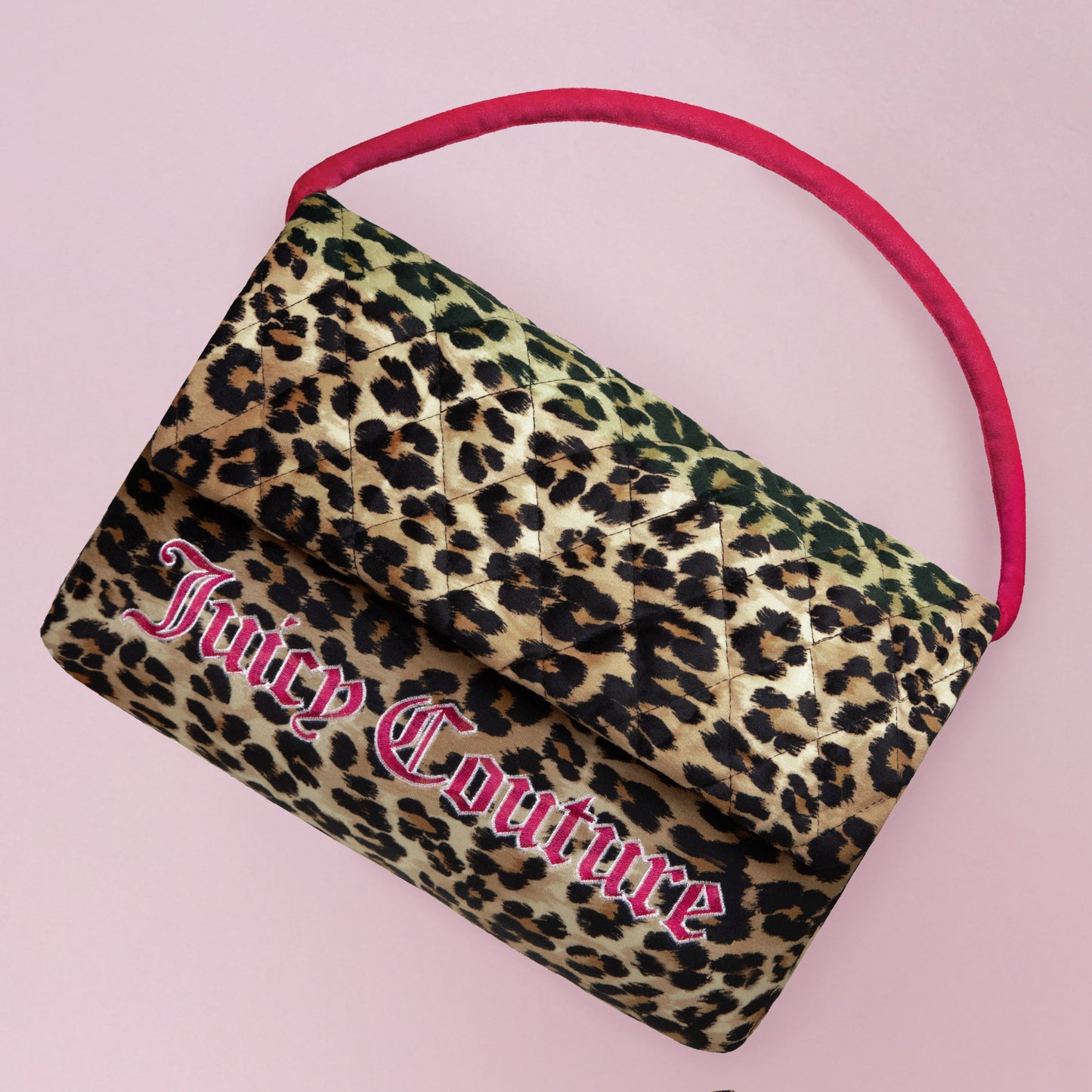 A quilted leopard print Juicy Couture handbag with a pink handle pops on a light pink background—pair it with the Purse Decorative Pillow for a stylish, coordinated look.