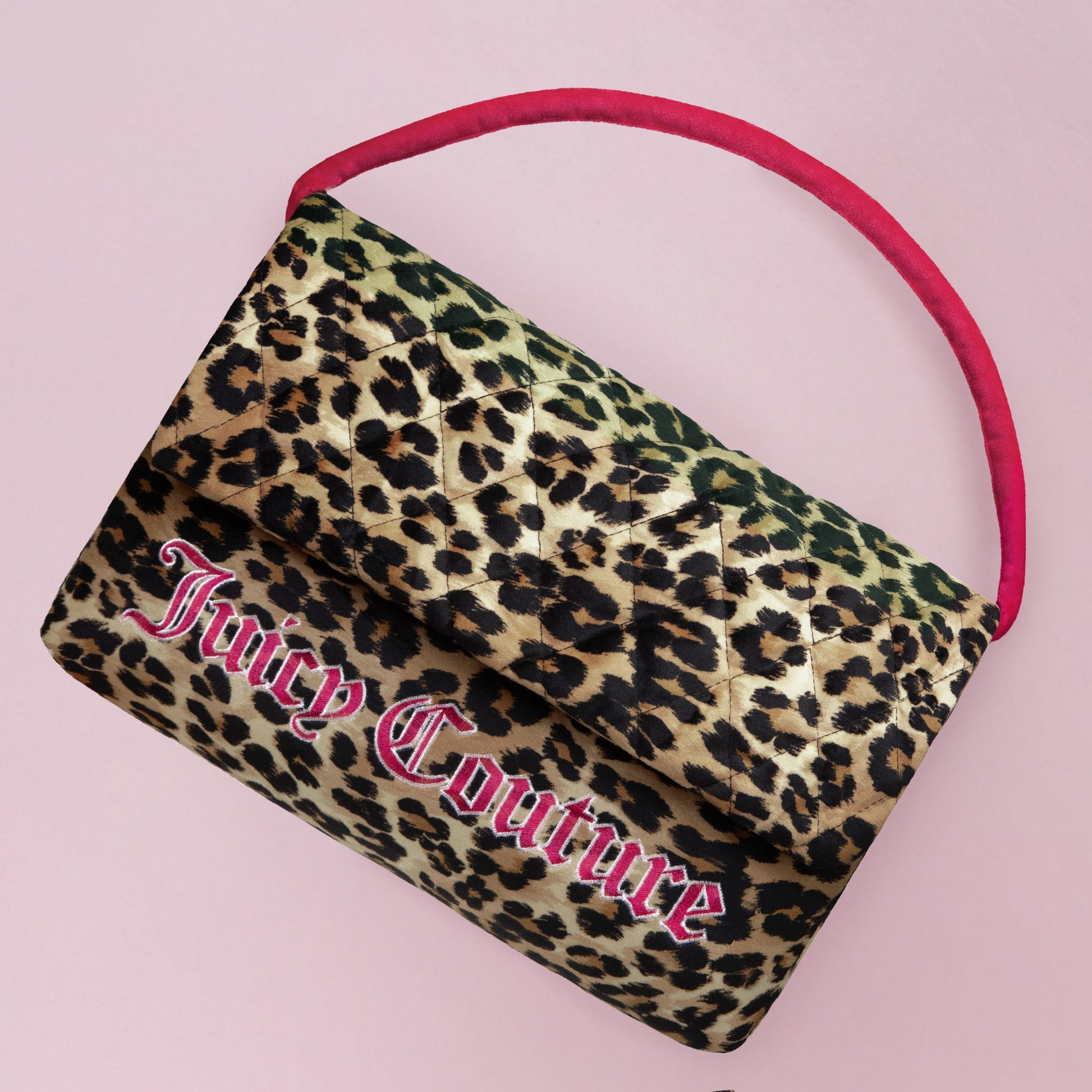 A quilted leopard print Juicy Couture handbag with a pink handle pops on a light pink background—pair it with the Purse Decorative Pillow for a stylish, coordinated look.