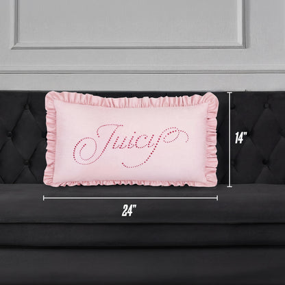 A Ruffle Decorative Pillow in pink with "Juicy" in cursive sparkles rests on a black tufted sofa. The pillow is 24"x14" and sits against a chic gray paneled wall for a stylish accent.