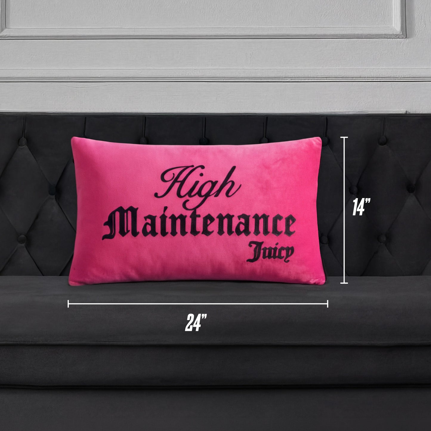 A bright pink Reversible Decorative Pillow with "High Maintenance Juicy" in black script sits on a dark tufted couch. White lines and measurements show the pillow is 24 inches wide and 14 inches tall.