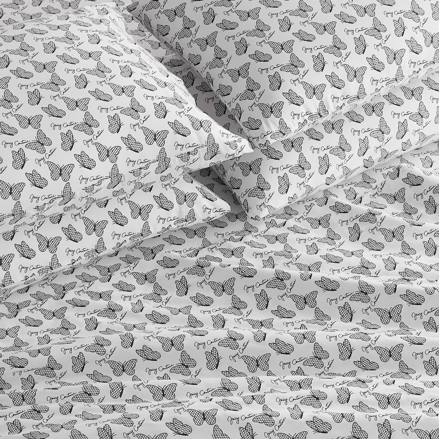 The Microfiber Sheet Set With Extra Pillowcases features a white base with black line-art butterflies, some accented with dots or stripes, and "Grey Cat" text throughout for a stylish touch to your bedding.