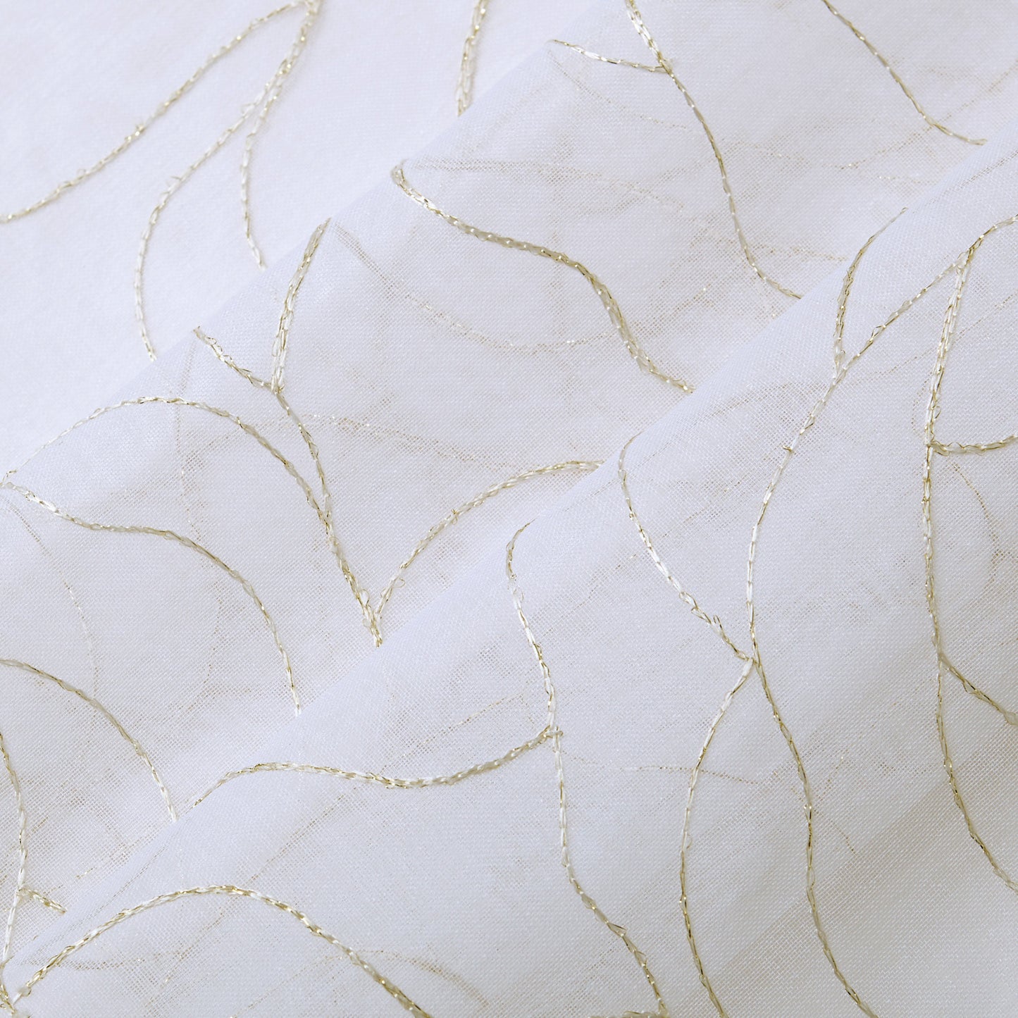 Rose Swirl Sheer Window Curtains feature white fabric adorned with delicate, curved gold lines forming an abstract, wavy pattern. The slightly raised lines add texture and an elegant, decorative touch to the smooth surface, making these curtains perfect for a grommet header style that blends sophistication with modern appeal.