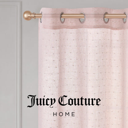 Close-up of the Aurora Sheer Window Curtain by Juicy Couture, featuring a pale pink sheer fabric with a grommet header on a gold rod. "Juicy Couture Home" is printed in black text on the curtain.