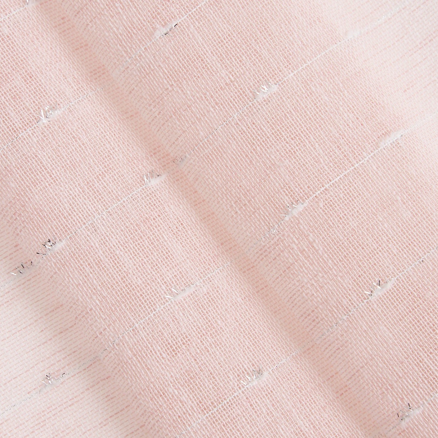 Close-up of soft, pale pink fabric with woven texture and subtle silver threads; the Aurora Sheer Window Curtain adds elegance and shimmer to any space.