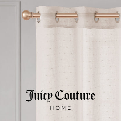 The cream-colored Aurora Sheer Window Curtain with a grommet header hangs on a gold rod. "Juicy Couture HOME" in black script appears at the bottom center of the image.