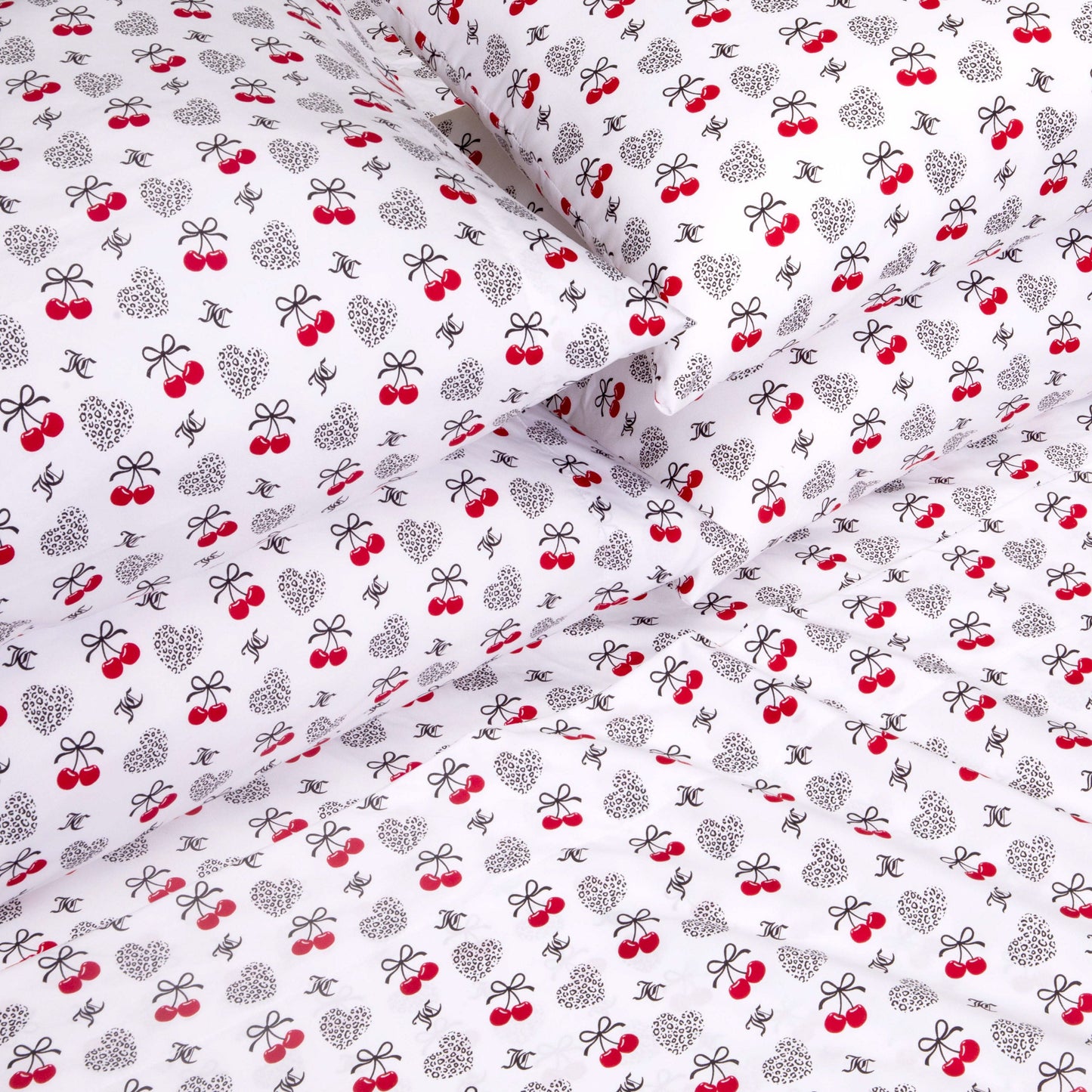 Indulge in luxury bedding with the Microfiber Sheet Set With Extra Pillowcases, showcasing white fabric embellished with black bows, polka-dotted hearts, red cherries, and dainty logo-inspired motifs for a playful and whimsical look. Crafted from premium microfiber, this stylish sheet set delivers both soft comfort and charming appeal to elevate your bedroom retreat.