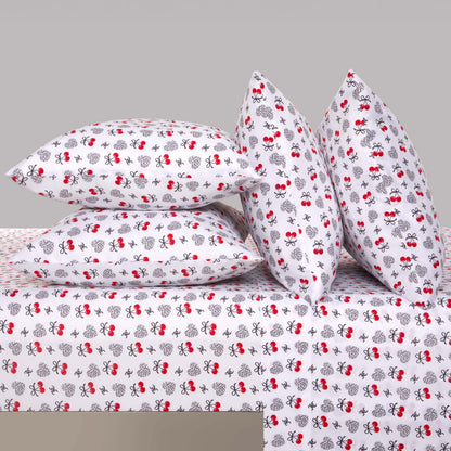 Four pillows and a sheet with a white background and red and black bee patterns are neatly arranged. This Microfiber Sheet Set With Extra Pillowcases features a playful, whimsical insect design, adding a cheerful atmosphere to your room while providing luxurious comfort for your bedding.