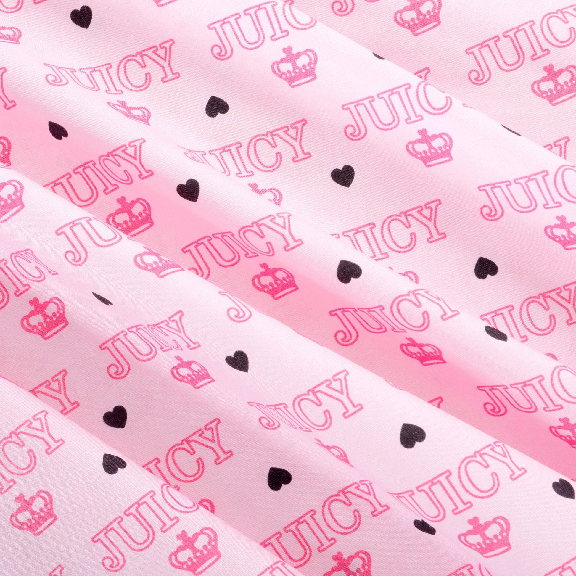 Bring a touch of luxury to your bedroom with the Microfiber Sheet Set With Extra Pillowcases, featuring a playful pink design with repeated JUICY text, crown symbols, and small black hearts. This stylish Juicy Couture sheet set elevates your bedding with its vibrant pattern and extra comfort.