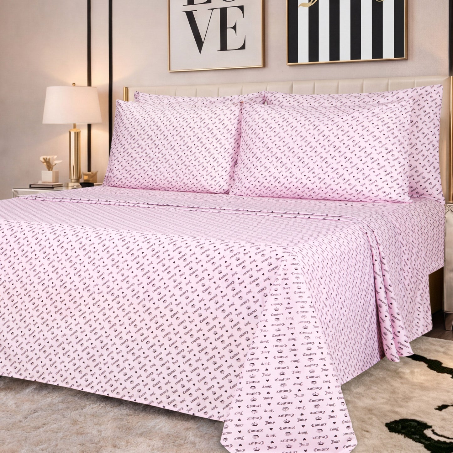 A neatly made bed featuring the Microfiber Sheet Set With Extra Pillowcases in a pink patterned luxury design, adorned with two large pillows, complemented by a bedside lamp and framed artwork above the headboard in a cozy, modern bedroom.