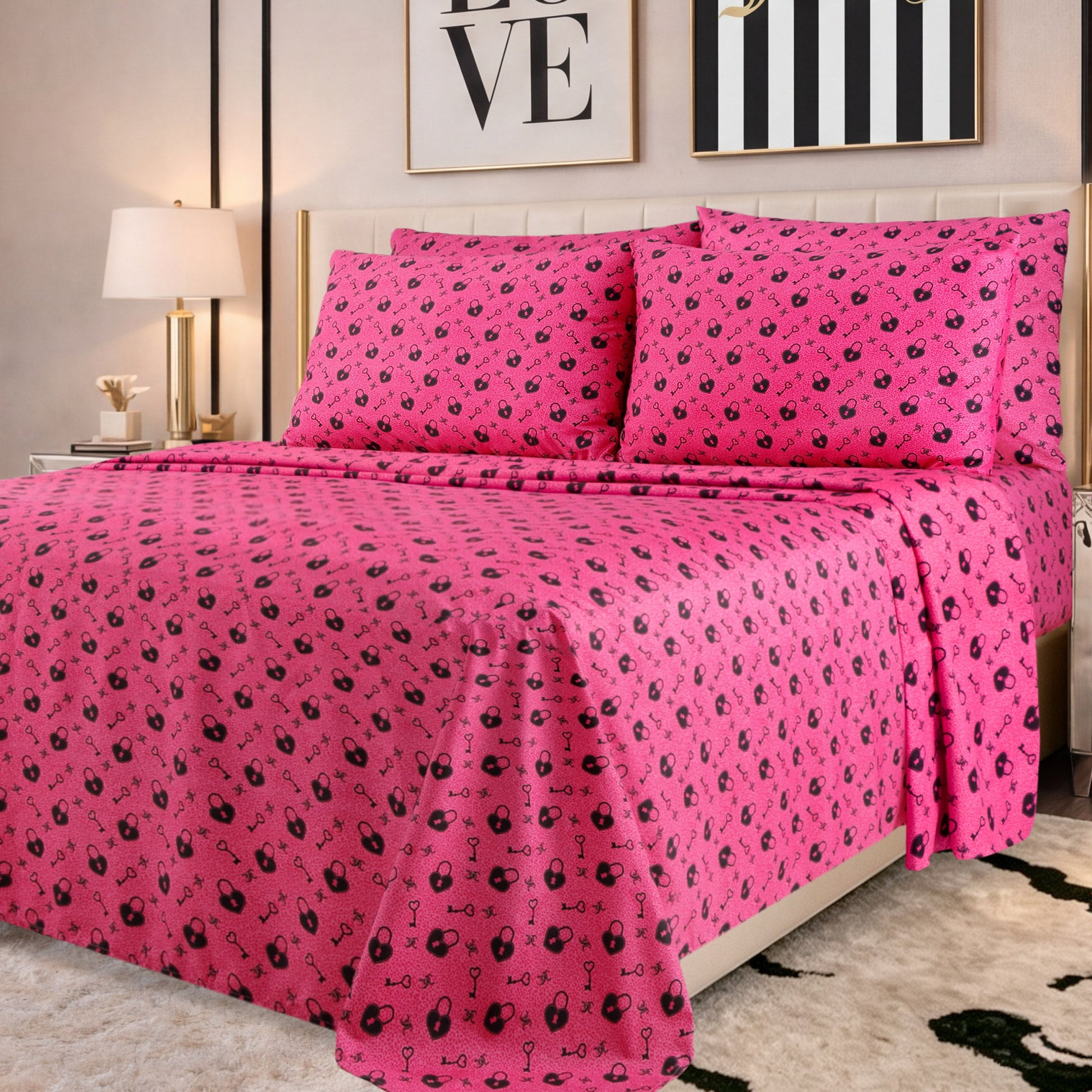 A neatly made bed with bright pink sheets and pillowcases featuring small black patterns, in a modern bedroom with framed wall art, a lamp, and a green and white rug—perfectly showcasing the chic style of the Microfiber Sheet Set With Extra Pillowcases for those who appreciate luxury bedding.