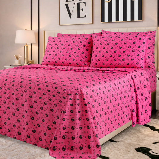 A neatly made bed with bright pink sheets and pillowcases featuring small black patterns, in a modern bedroom with framed wall art, a lamp, and a green and white rug—perfectly showcasing the chic style of the Microfiber Sheet Set With Extra Pillowcases for those who appreciate luxury bedding.