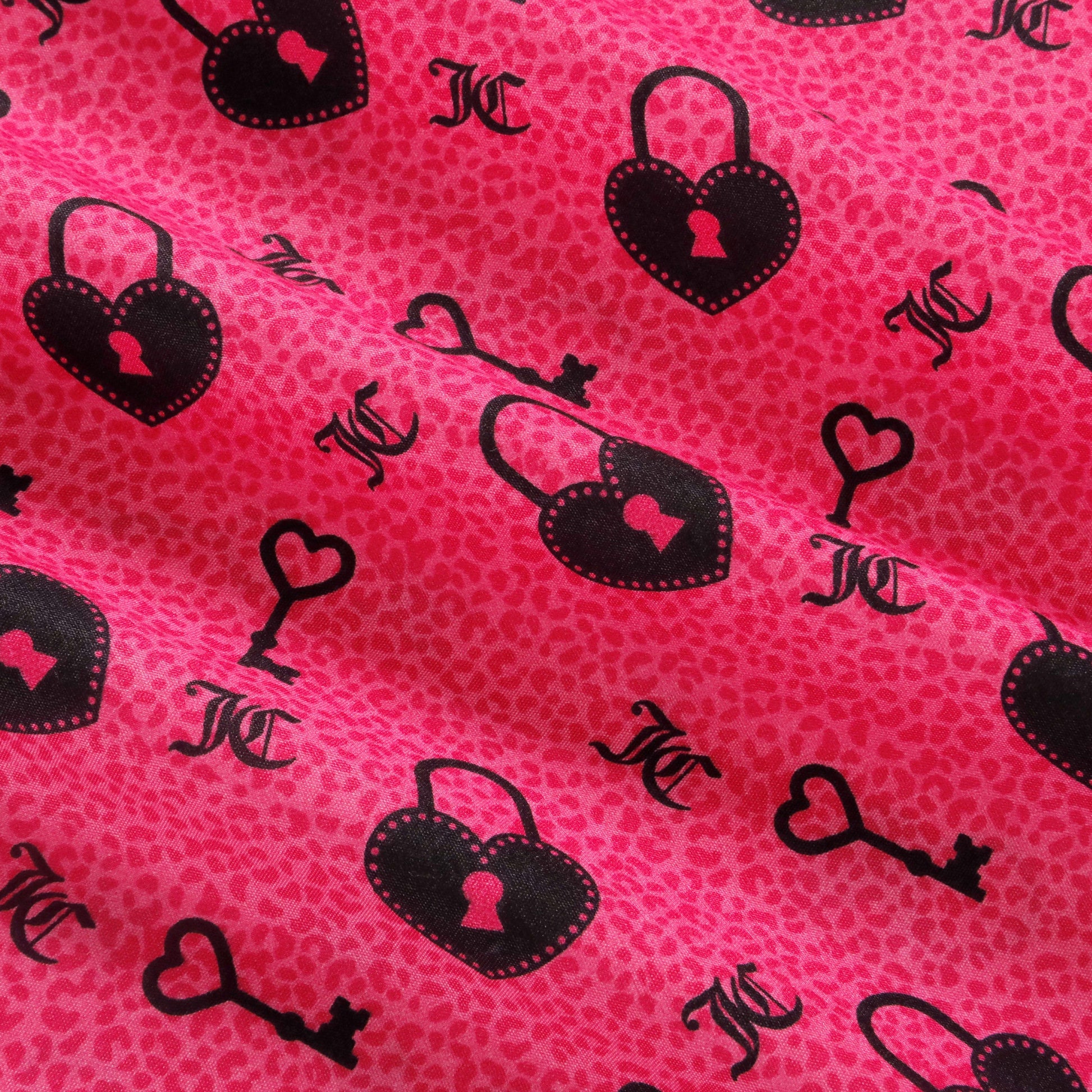 Infuse your space with vibrant style using the Microfiber Sheet Set With Extra Pillowcases. Crafted from ultra-soft microfiber, this set showcases a bright pink fabric adorned with a subtle animal print and playful black heart-shaped locks, skeleton keys, and JC initials in a repeating designer pattern. Perfect for anyone who loves luxurious bedding with eye-catching details, it transforms your bedroom into a chic retreat.