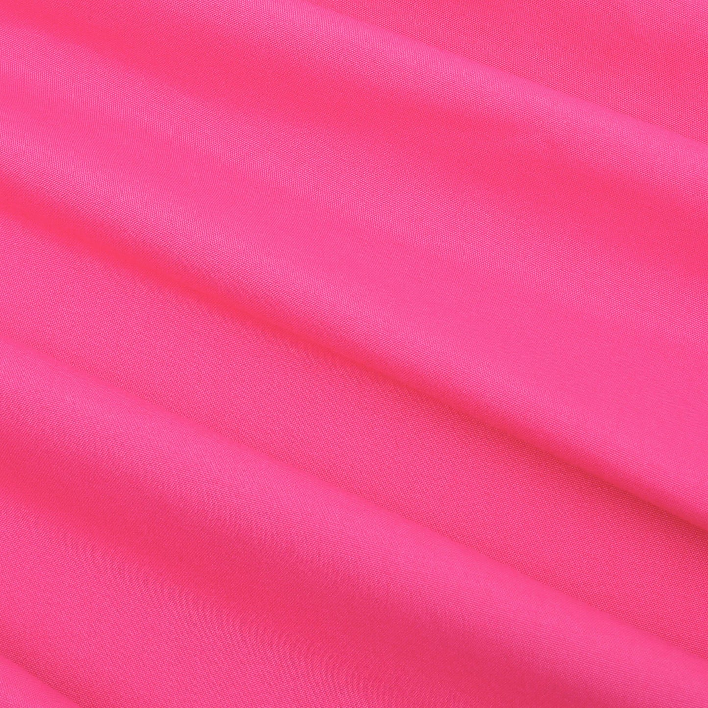 Experience the luxurious feel of our Microfiber Sheet Set With Extra Pillowcases, featuring bright pink fabric adorned with soft folds running diagonally across the surface—creating gentle shadows and a smooth texture reminiscent of luxury bedding.